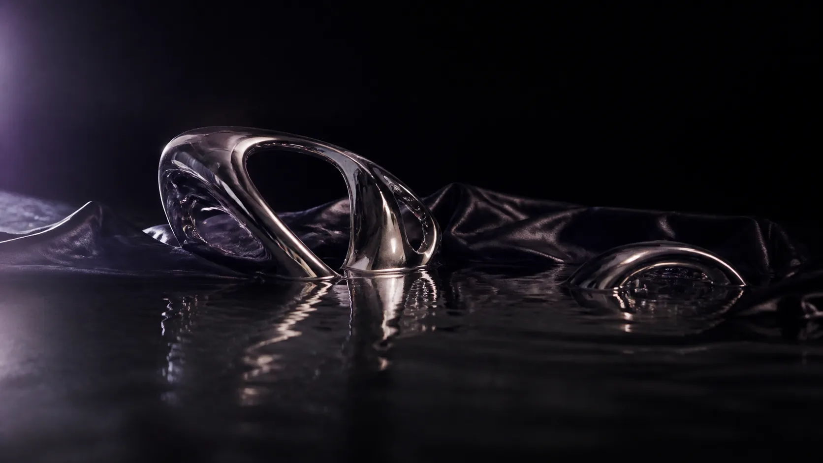 Chrome forms and black silk reflected in water
